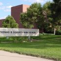 One juvenile is under arrest and another is on the run after a shooting last month near Doherty High School in Colorado Springs